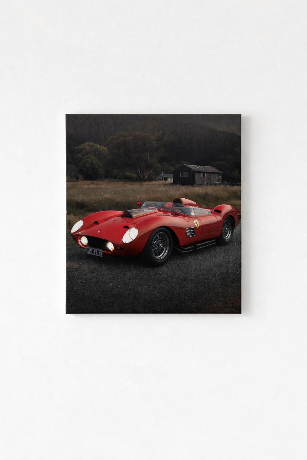 Vintage red Ferrari racing car parked in a moody rural landscape, printed on a velvet wall tapestry