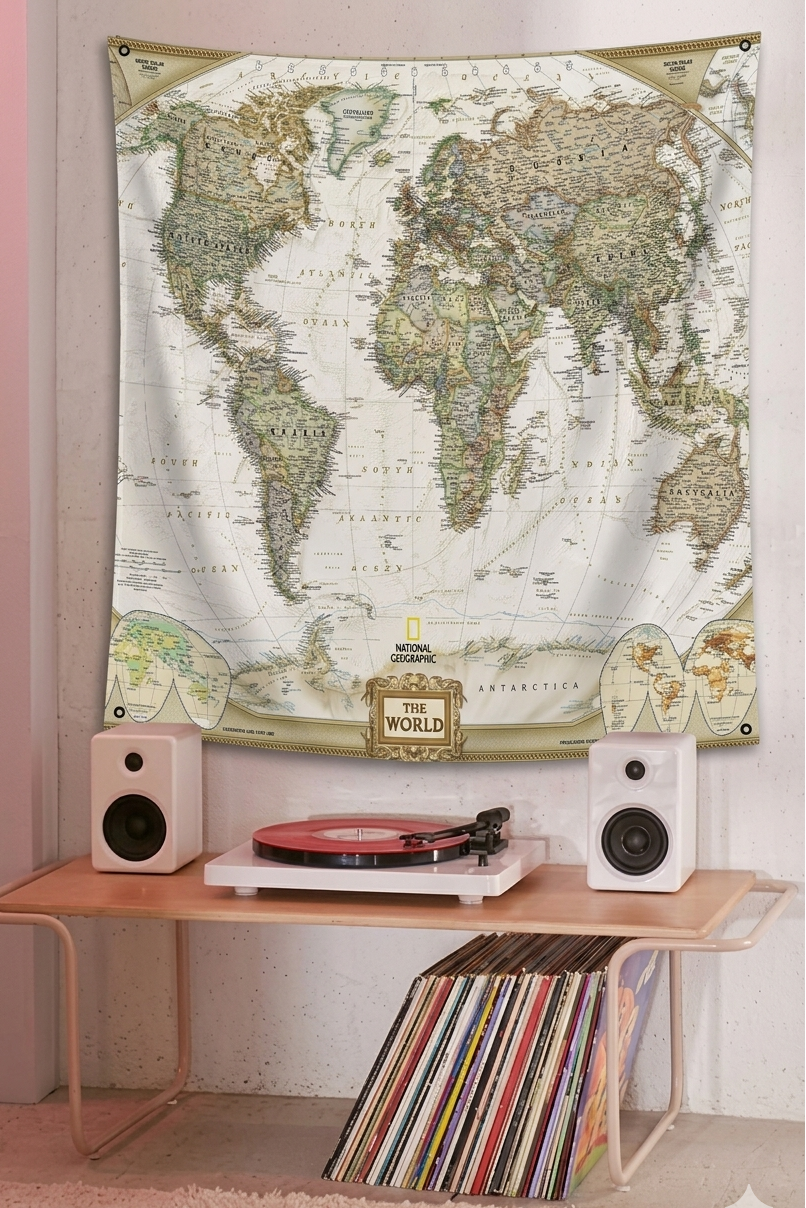 World map velvet tapestry hung on a wall above a record turntable and vinyl collection